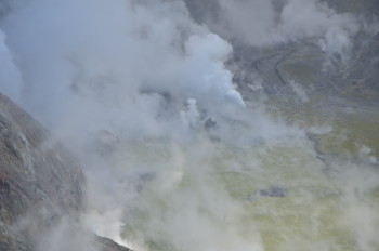 Figure 2: View into crater of Whakaari/White Island, 24 March 2024 showing geysering, ejecting steam and dark material. Photograph credit: Brad Scott, GNS Science. 