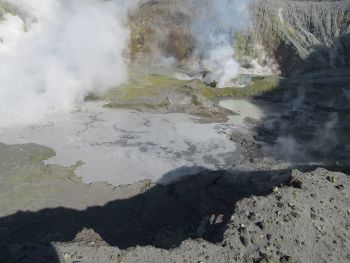 Image of the enlarged lake at White Island. The strong steam emission on the left marks the location of the active vent January-April 2013 (now drowned). The lava extrusion is in the centre rear.