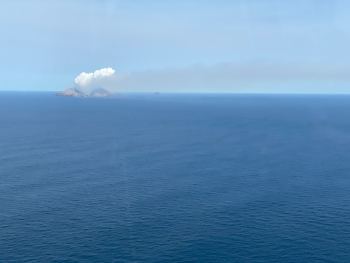 The vivid white steam and gas plume above the volcano