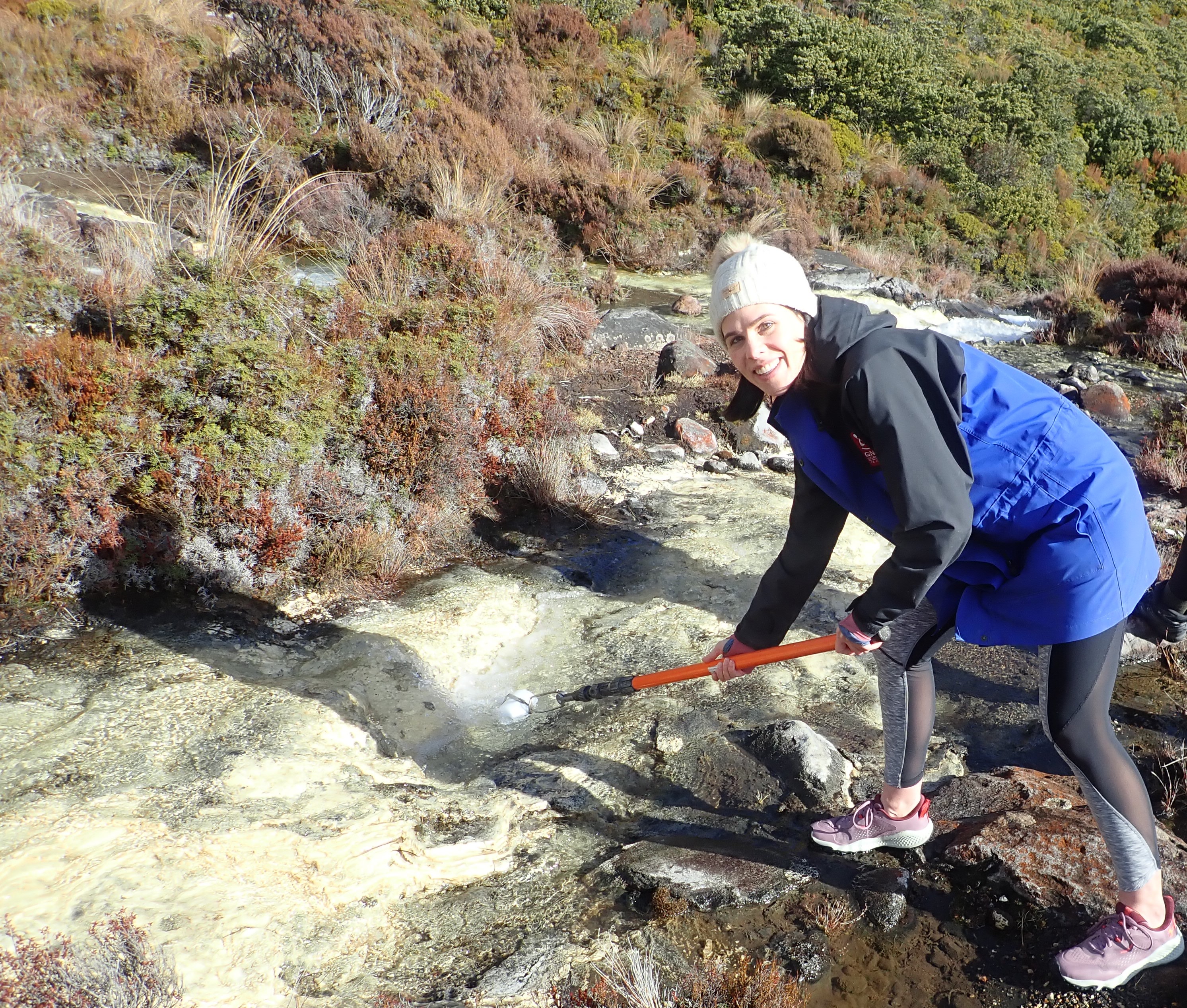 Rachel White collecting a water sample